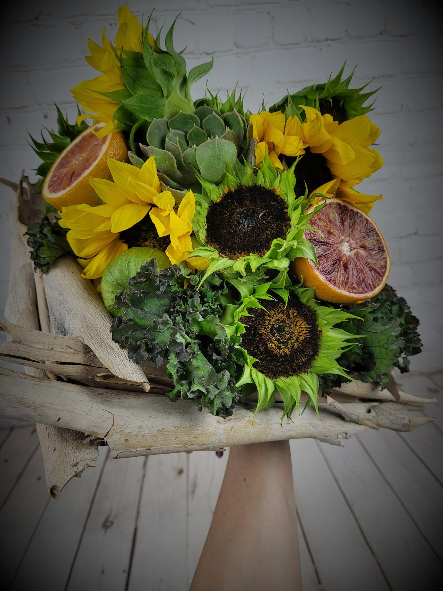Sunflowers and fruits in a bouquet