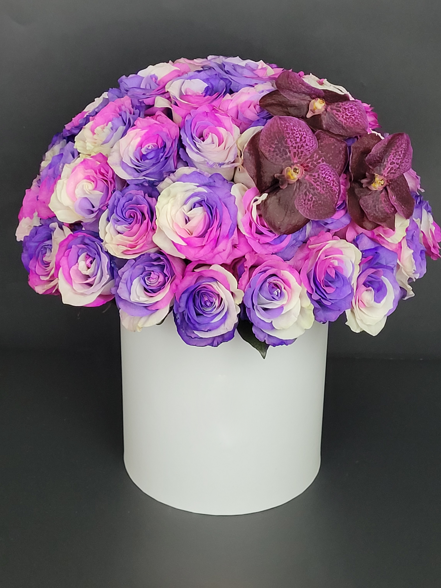 Dyed roses and Vanda orchids in white box