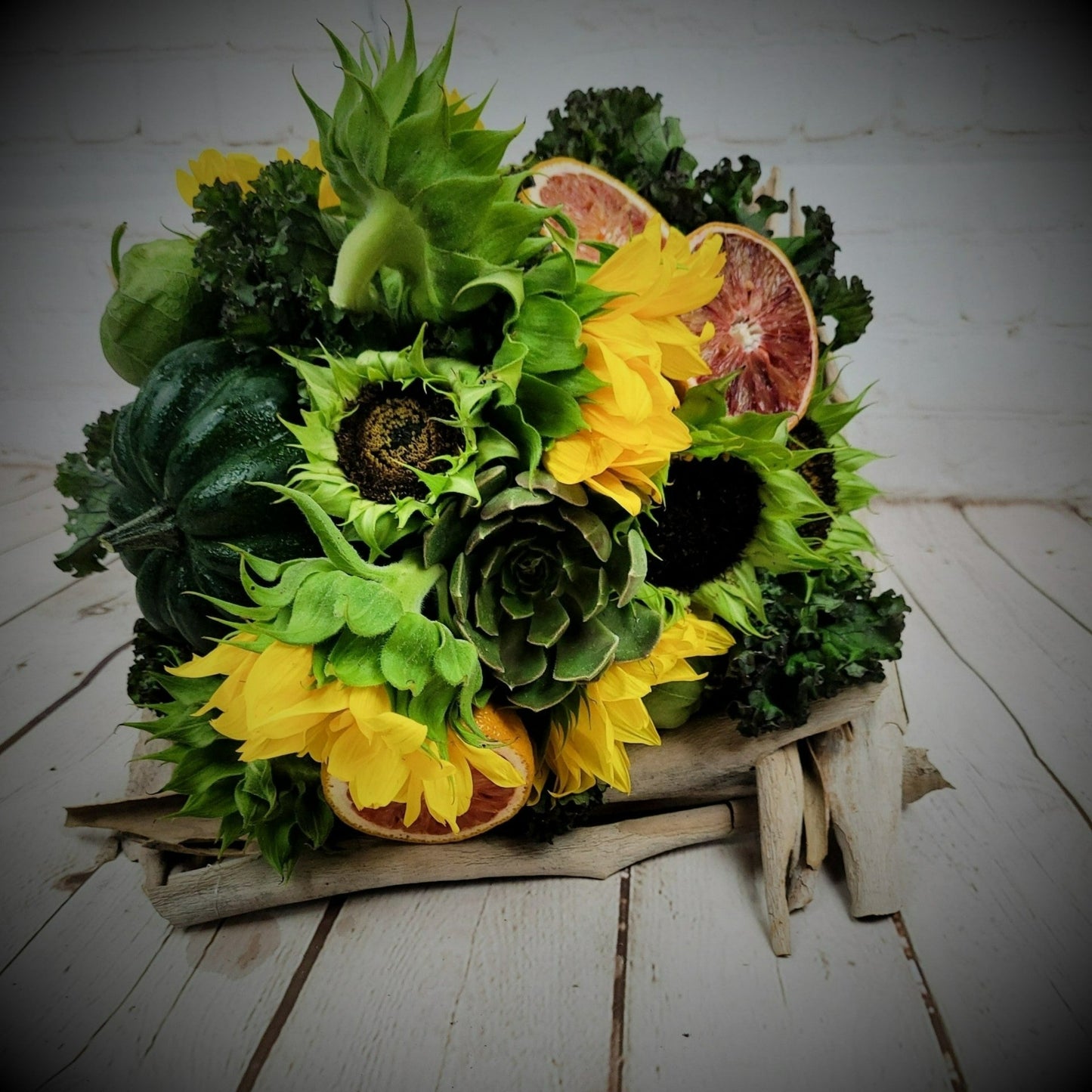 Sunflowers and fruits in a bouquet