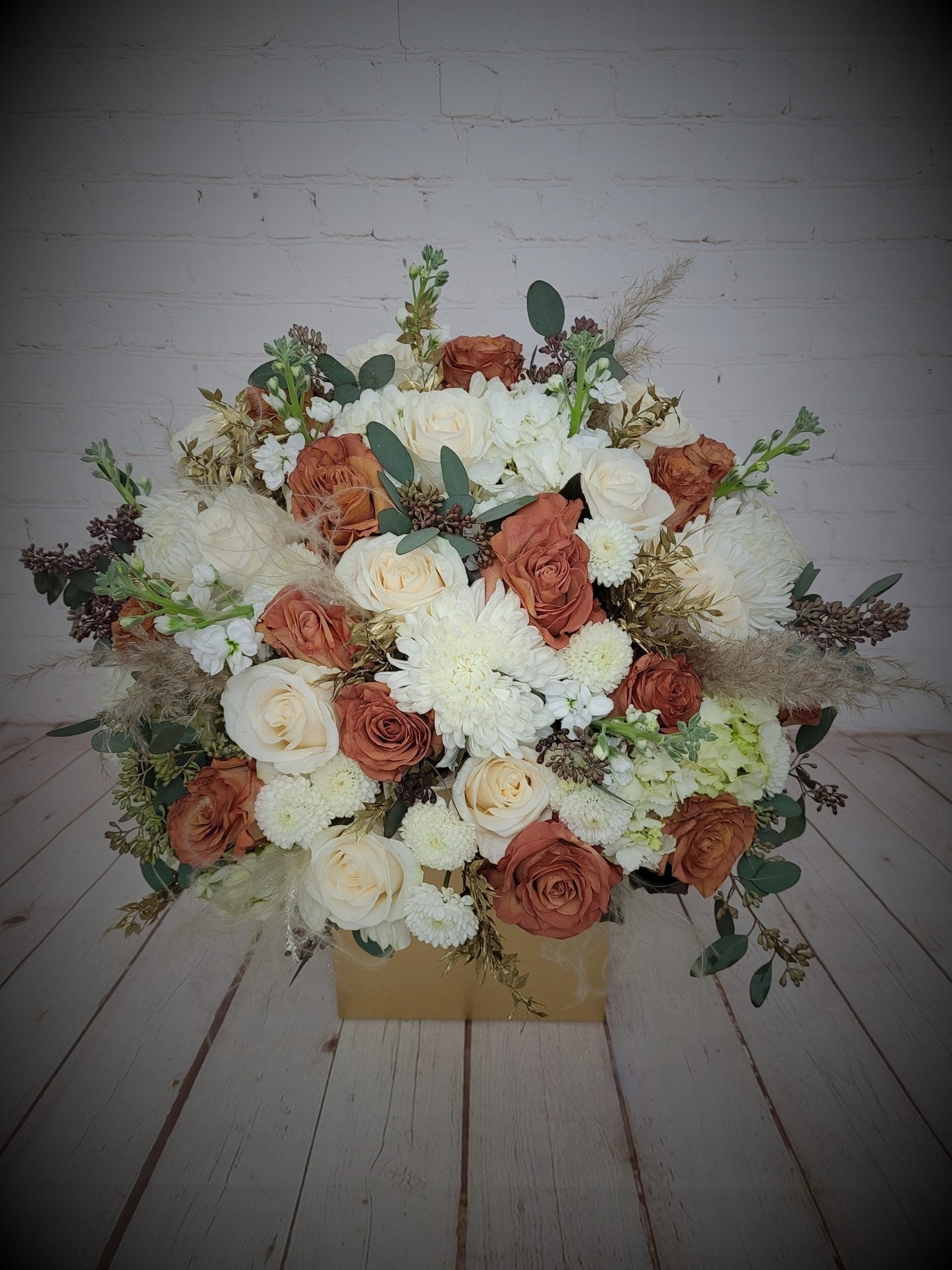 Brown and white mixed arrangement in gold box