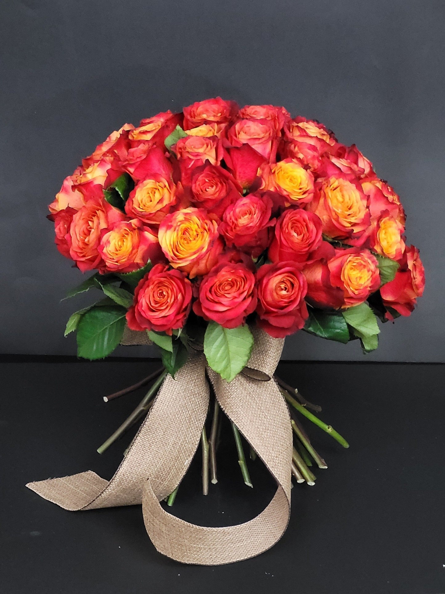 Orange roses with burlap ribbon