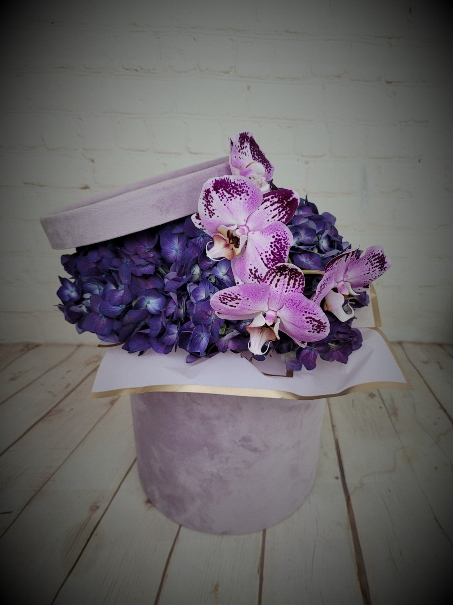 Purple hydrangea and orchids in box