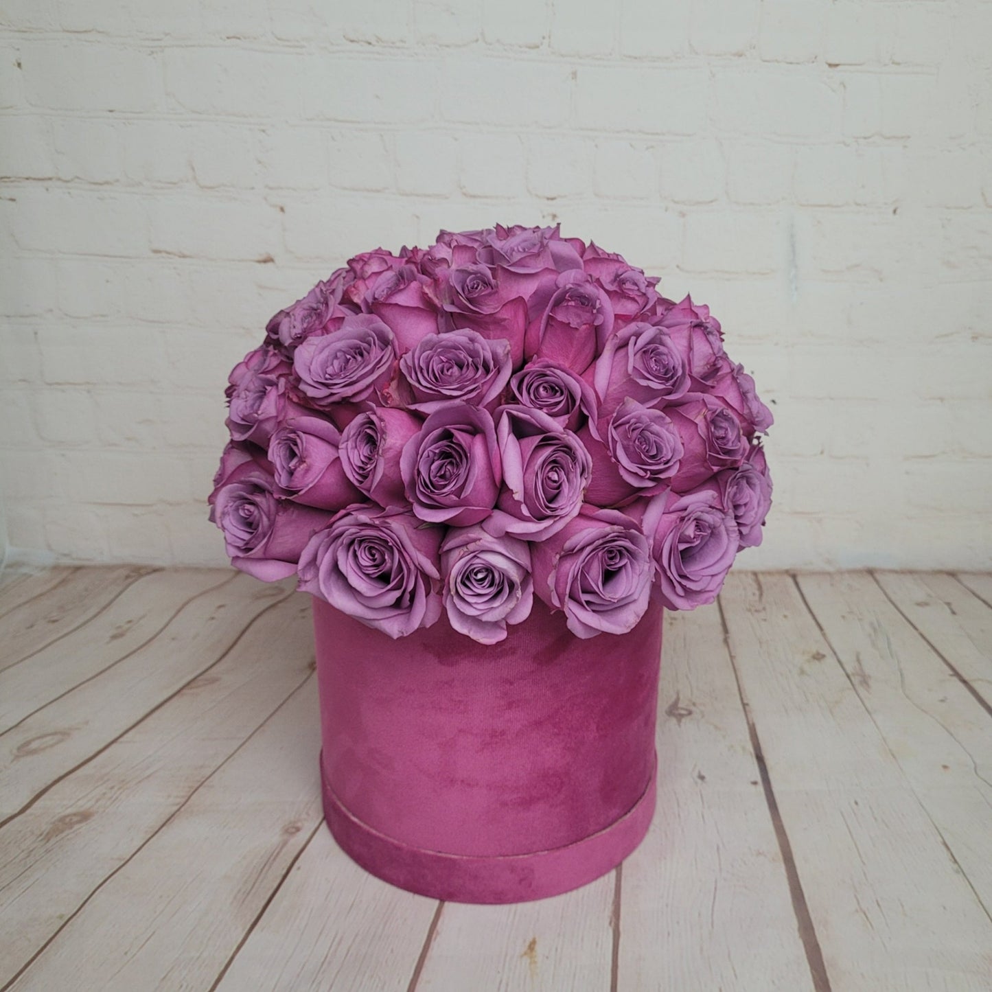 purple roses in box
