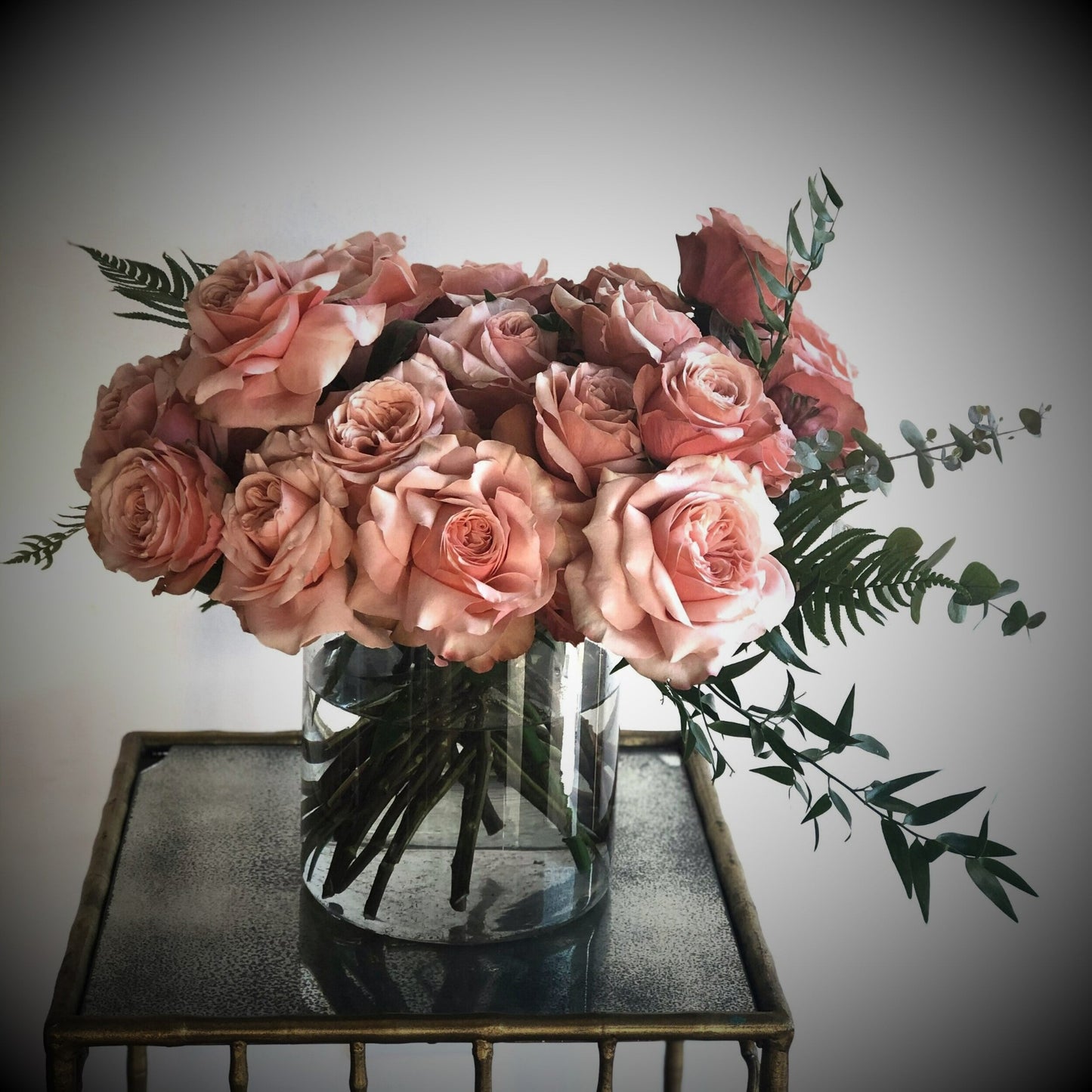Pink roses and greenery in a vase