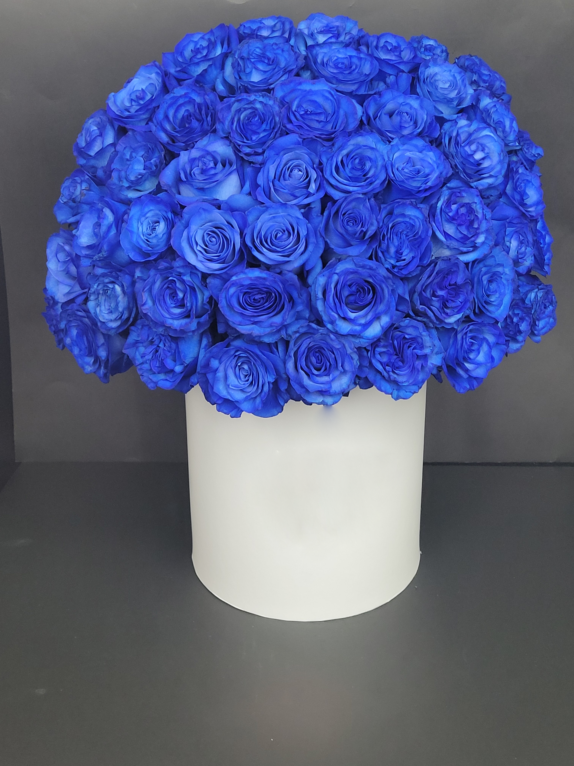 Blue roses in white box