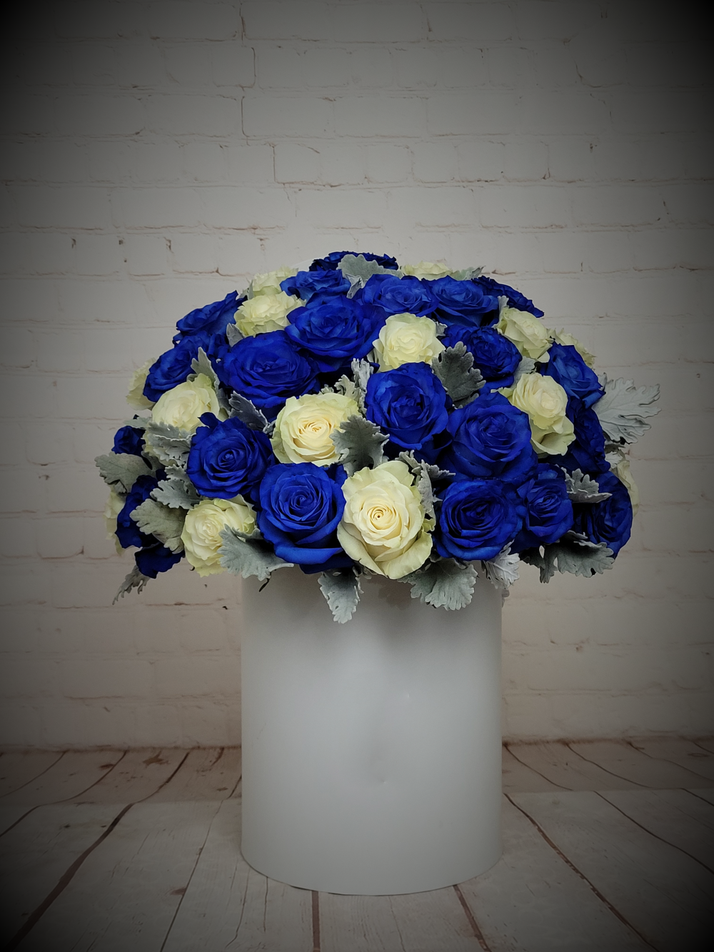 Blue and white roses in white box