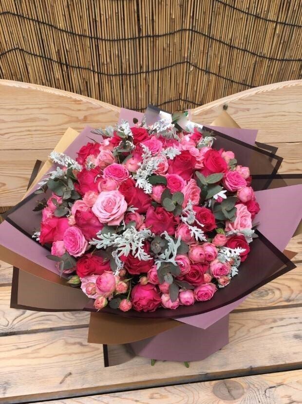 Mix bouquet with pink and hot pink roses with seasonal greenery