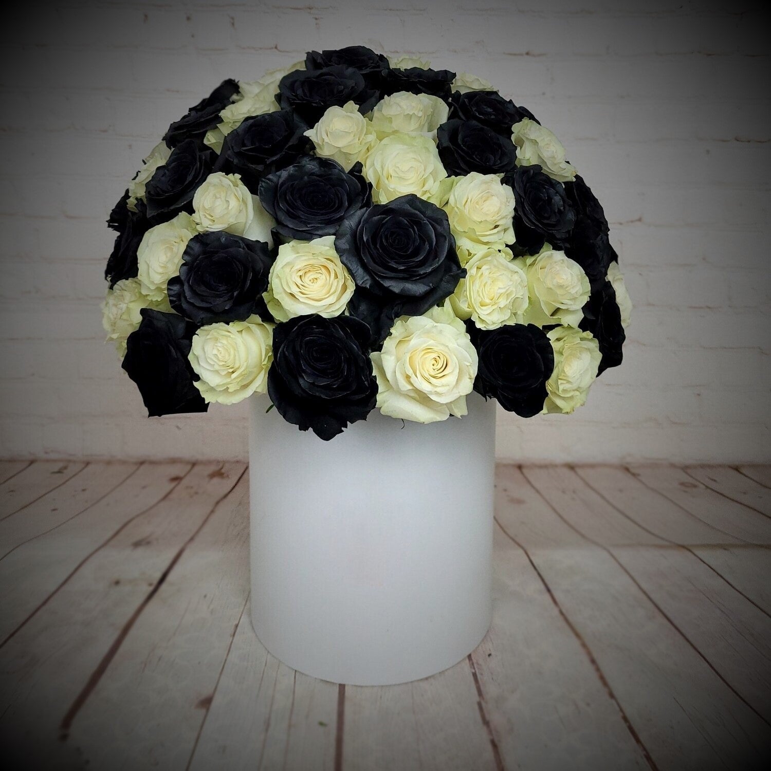 Black and white roses in a white box