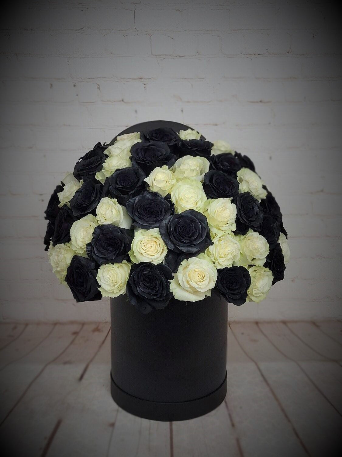 Black and white roses in a box