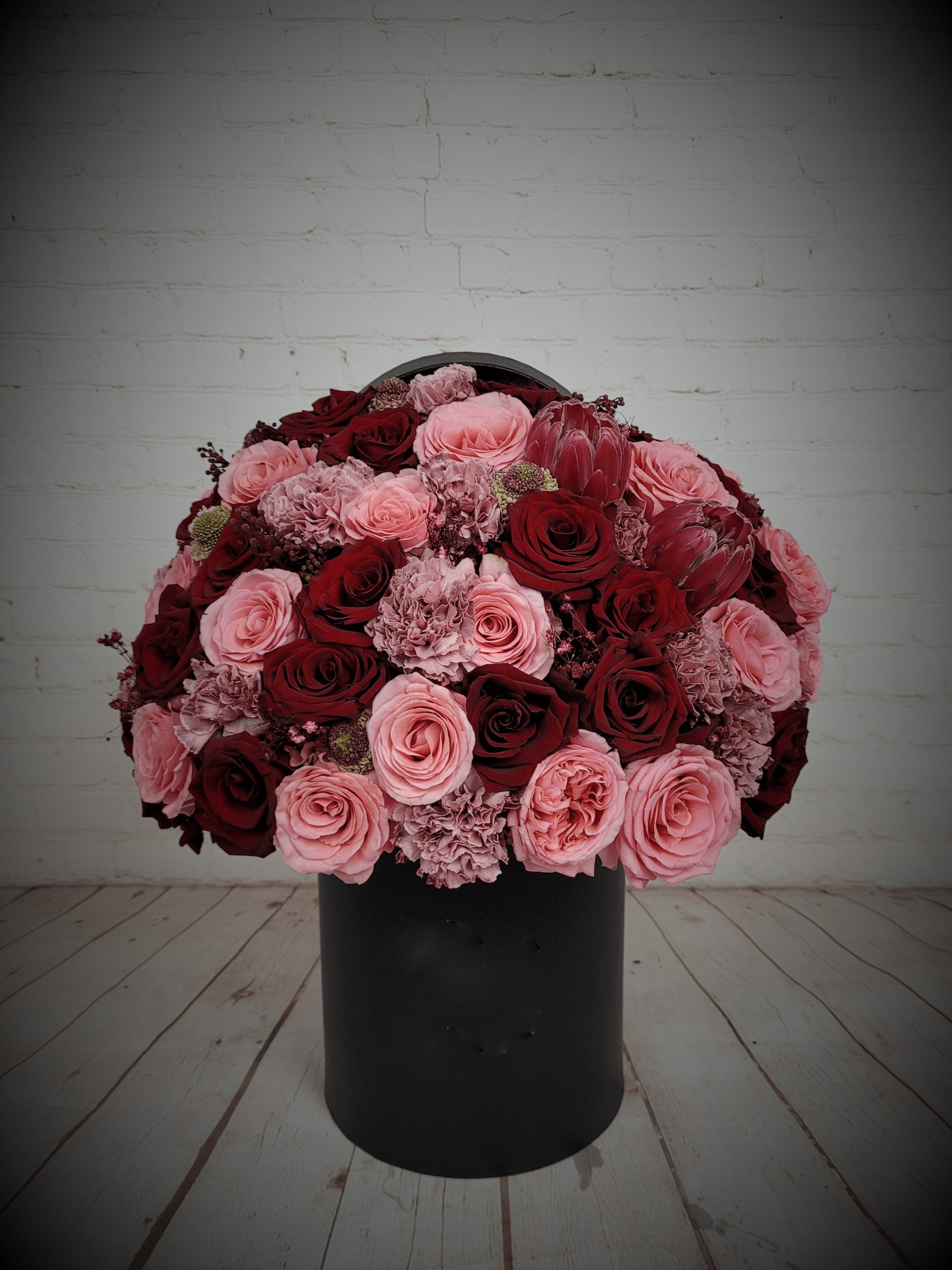Red and pink arrangement in black box